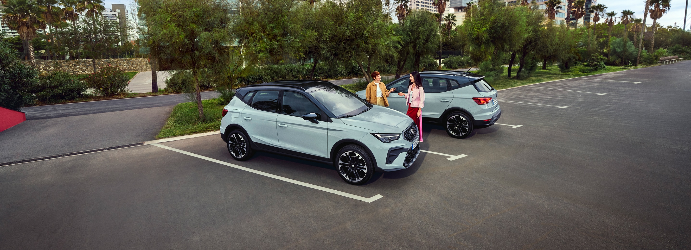 Woman dressed in bright colours seat inside the SEAT Arona 2025