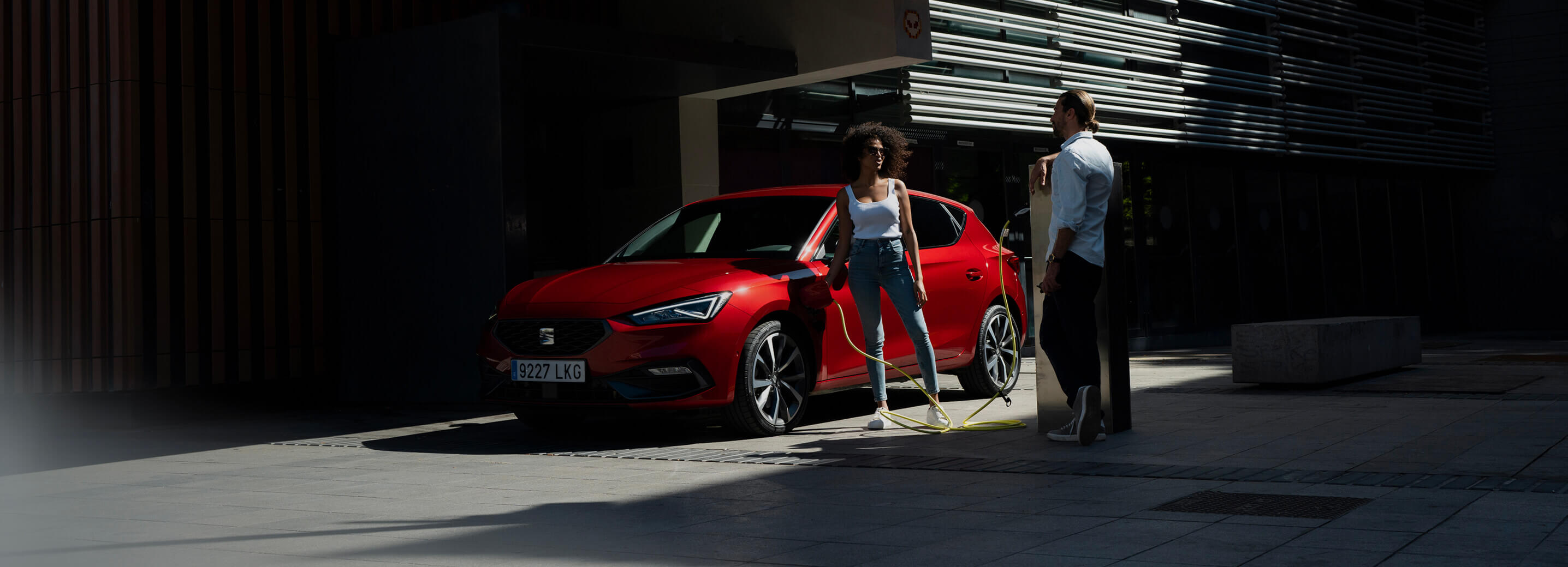 seat leon parked on a city street with a person stepping out of the vehicle.