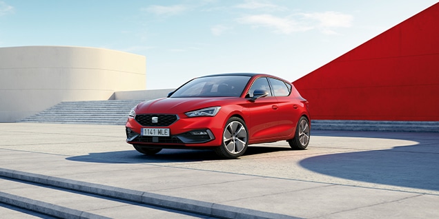red seat leon parked against a modern urban background, showcasing fuel economy and low emissions for environmentally conscious drivers. red seat leon parked against a modern urban background, showcasing fuel economy and low emissions for environmentally conscious drivers.