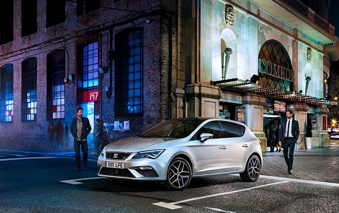SEAT Leon parked outside in two urban and elegant scenes